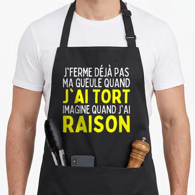 Tablier de cuisine noir avec inscription blanche et jaune affirmant avoir toujours raison, style typographie moderne.