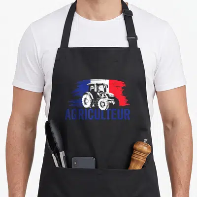 Tablier de cuisine noir avec illustration de tracteur blanc sur fond tricolore et le mot Agriculteur en bleu.