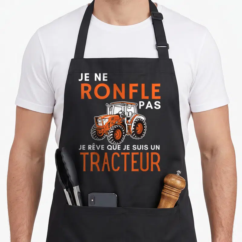 Tablier de cuisine noir avec illustration de tracteur orange et texte blanc et orange Je ne ronfle pas je rêve que je suis un tracteur