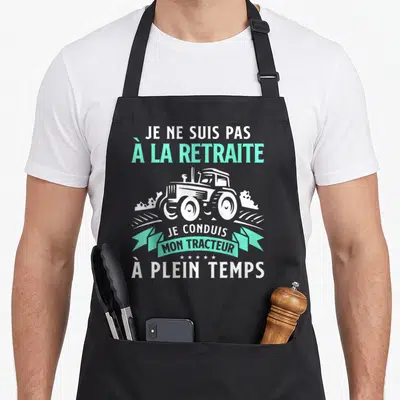 Tablier de cuisine noir avec illustration de tracteur et texte blanc turquoise Je ne suis pas à la retraite Je conduis mon tracteur à plein temps