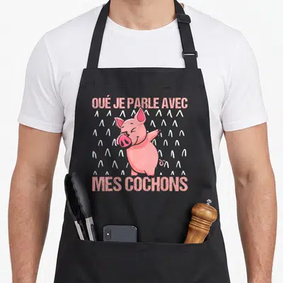 Tablier de cuisine noir avec illustration d'un cochon rose et texte Oué je parle avec mes cochons en lettres roses.