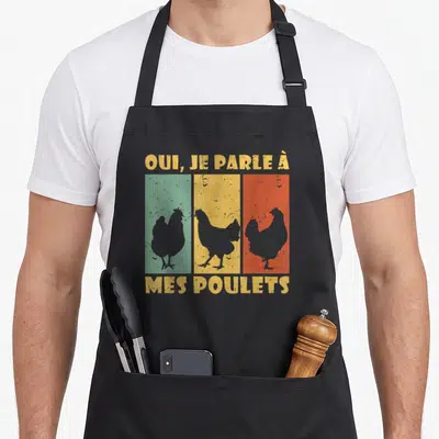 Tablier de cuisine noir avec trois silhouettes de poulets sur fonds vert jaune et orange et texte jaune vintage.