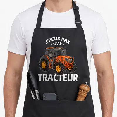Tablier de cuisine noir avec illustration d'un tracteur orange et texte blanc J'peux pas j'ai tracteur