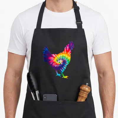 Tablier de cuisine noir avec une illustration de poulet aux motifs tie dye multicolores spirales.