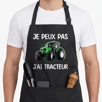 Tablier de cuisine noir avec illustration d'un tracteur vert et texte blanc Je peux pas j'ai tracteur.