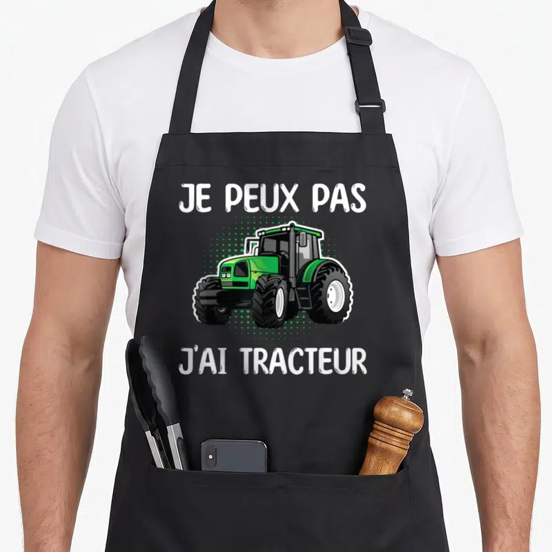 Tablier de cuisine noir avec illustration d'un tracteur vert et texte blanc Je peux pas j'ai tracteur.