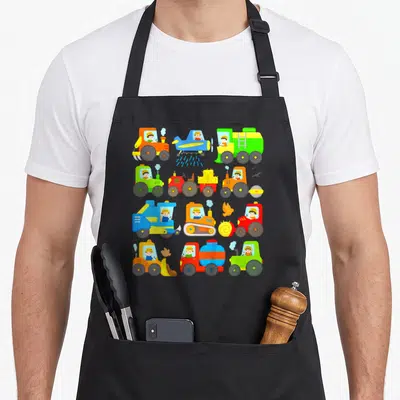 Tablier de cuisine noir avec enfants tracteurs colorés et matériel agricole imprimé en grille.