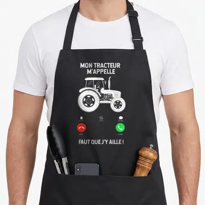 Tablier de cuisine noir avec illustration blanche d'un appel téléphonique entrant et d'un tracteur agricole classique.