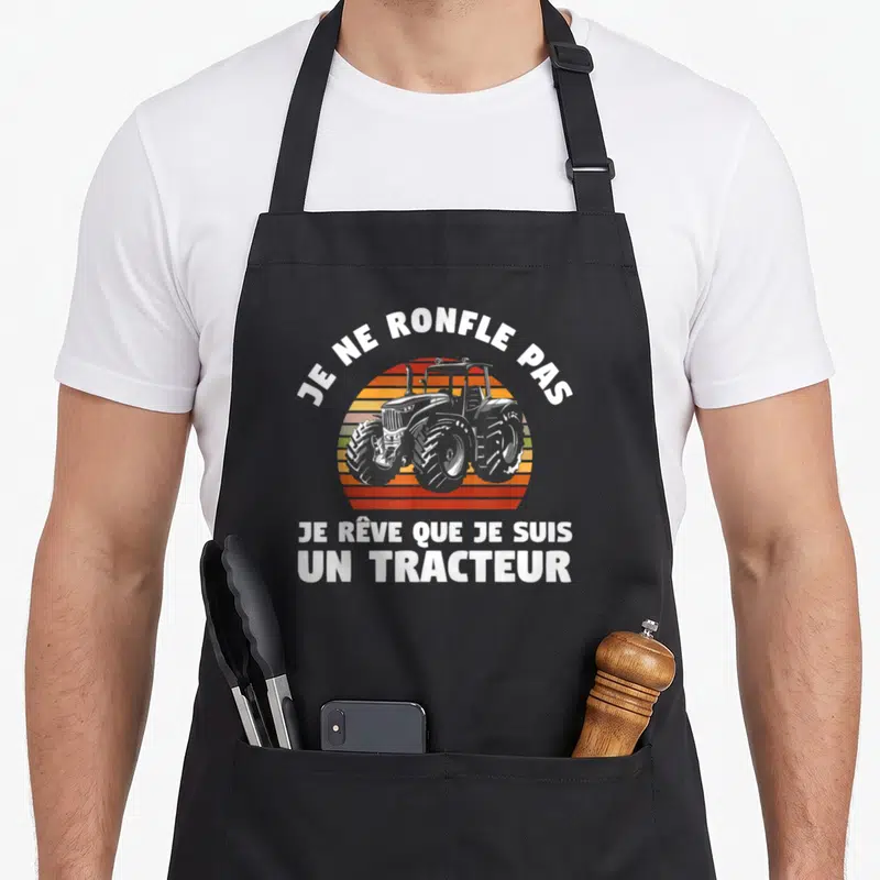Tablier de cuisine noir avec illustration de tracteur sur fond rétro et texte blanc Je ne ronfle pas je rêve que je suis un tracteur.