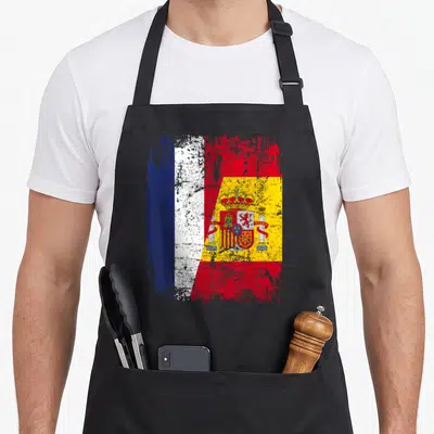Tablier de cuisine noir avec drapeau France et Espagne fusionnés en style vintage délavé.