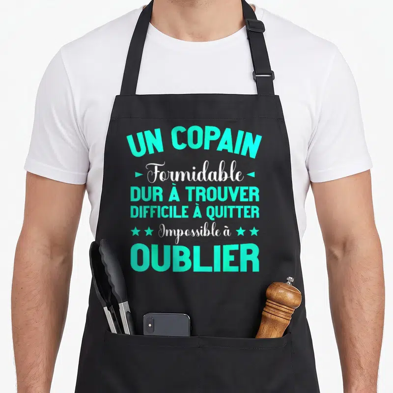 Tablier de cuisine noir avec inscription turquoise et blanche célébrant un copain formidable et impossible à oublier.