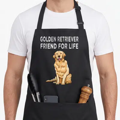 Tablier de cuisine noir avec illustration d'un chien doré et texte blanc en anglais.