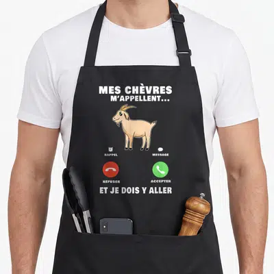 Tablier de cuisine noir avec illustration d'une chèvre beige et boutons d'appel téléphonique rouge et vert.