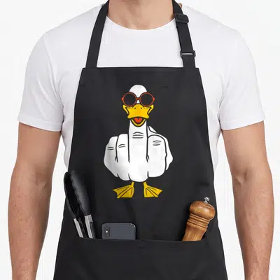 Tablier de cuisine noir avec un canard blanc antisocial portant des lunettes rouges et faisant un doigt d'honneur.
