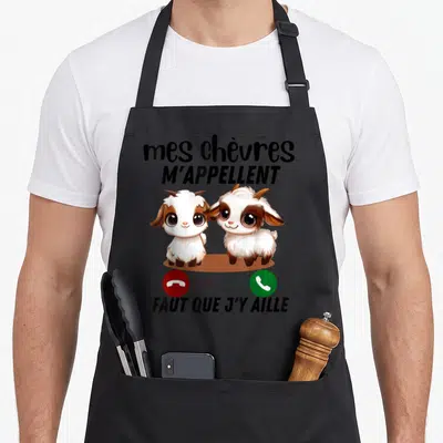 Tablier de cuisine noir avec deux chèvres mignonnes et le texte mes chèvres m'appellent faut que j'y aille