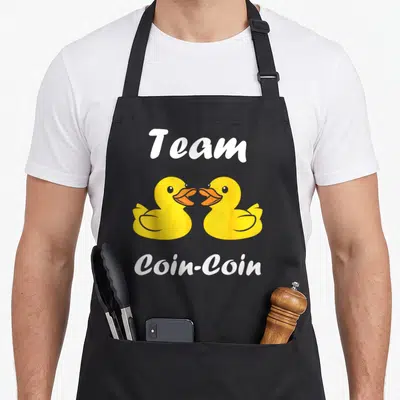 Tablier de cuisine noir avec deux canards jaunes et l'inscription Team Coin-Coin en blanc.