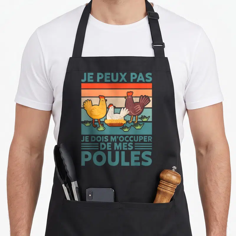 Tablier de cuisine noir avec trois poules colorées et le texte Je peux pas je dois m'occuper de mes poules en bleu turquoise.