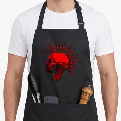 Tablier de cuisine noir avec illustration d'un crâne rouge stylisé punk portant une coiffe d'os pointus en mohawk.