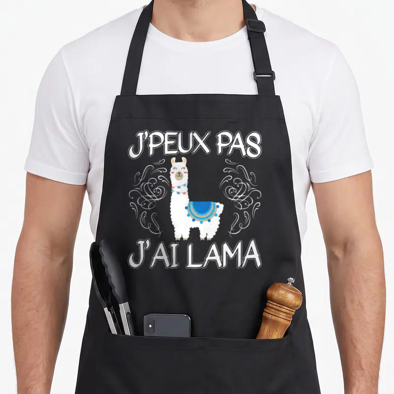 Tablier de cuisine noir avec illustration d'un lama blanc et texte Je peux pas j'ai lama en lettres blanches.