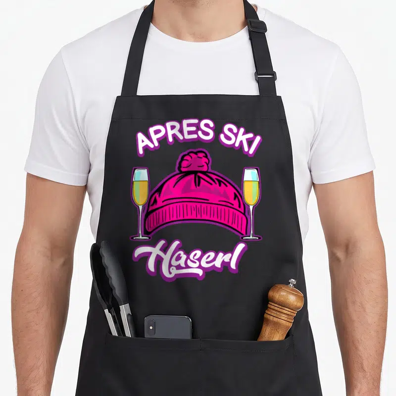 Tablier de cuisine noir avec bonnet rose, deux flûtes de champagne et le texte Après Ski Haserl imprimé en blanc et violet.