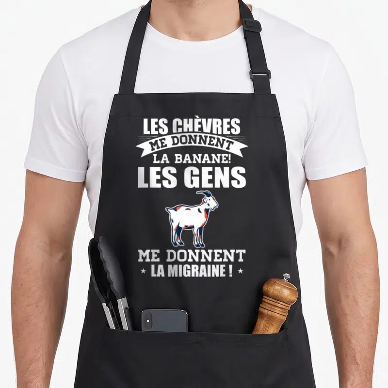 Tablier de cuisine noir avec illustration de chèvre et texte blanc Les Chèvres me donnent la banane les gens me donnent la migraine