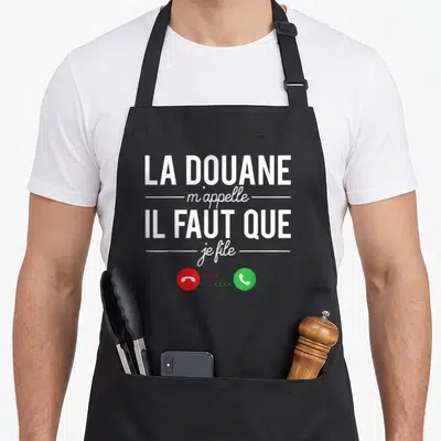 Tablier de cuisine noir avec le texte La Douane m'appelle Il Faut Que Je File et des icônes de téléphone rouge et vert.