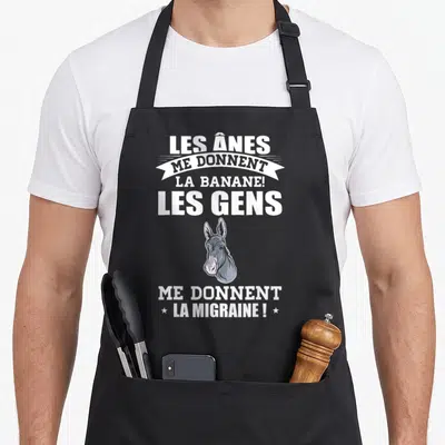 Tablier de cuisine noir avec illustration tête d'âne et texte blanc Les ânes me donnent la banane les gens me donnent la migraine.