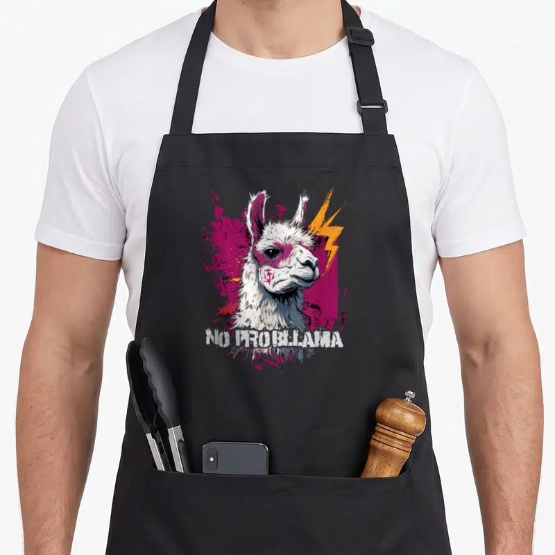 Tablier de cuisine noir avec illustration d'un alpaga blanc aux éclairs roses et texte No Problrama en bas.