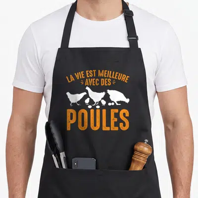 Tablier de cuisine noir avec silhouettes blanches de poules et texte orange La vie est meilleure avec des poules.