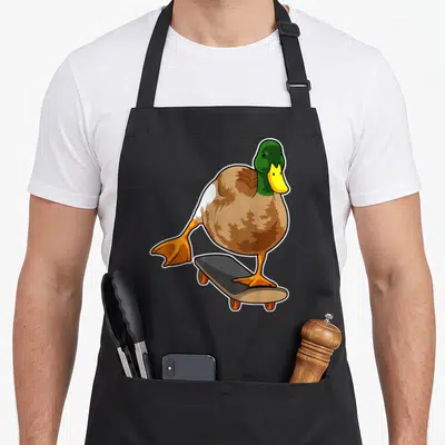 Tablier de cuisine noir avec illustration d'un canard skater sur planche à roulettes orange.