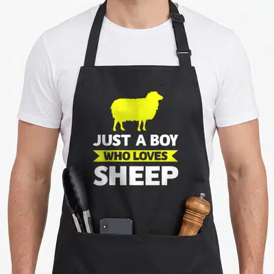 Tablier de cuisine noir avec silhouette mouton jaune et texte blanc Juste un boy who loves sheep
