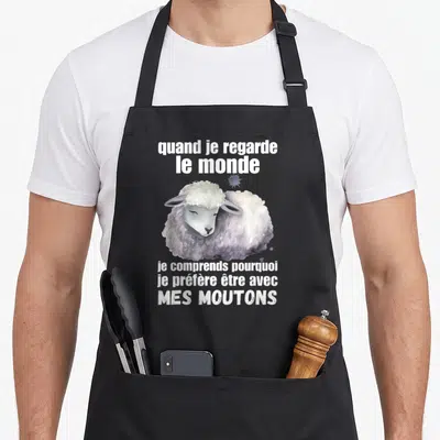 Tablier de cuisine noir avec illustration aquarelle d'un mouton blanc et texte humoristique sur les préférences animales.