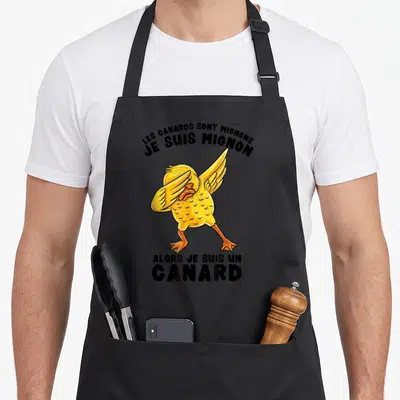 Tablier de cuisine noir avec un canard jaune effectuant le dabbing et le texte Les canards sont mignons alors je suis un canard.