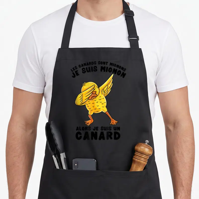 Tablier de cuisine noir avec un canard jaune effectuant le dabbing et le texte Les canards sont mignons alors je suis un canard.