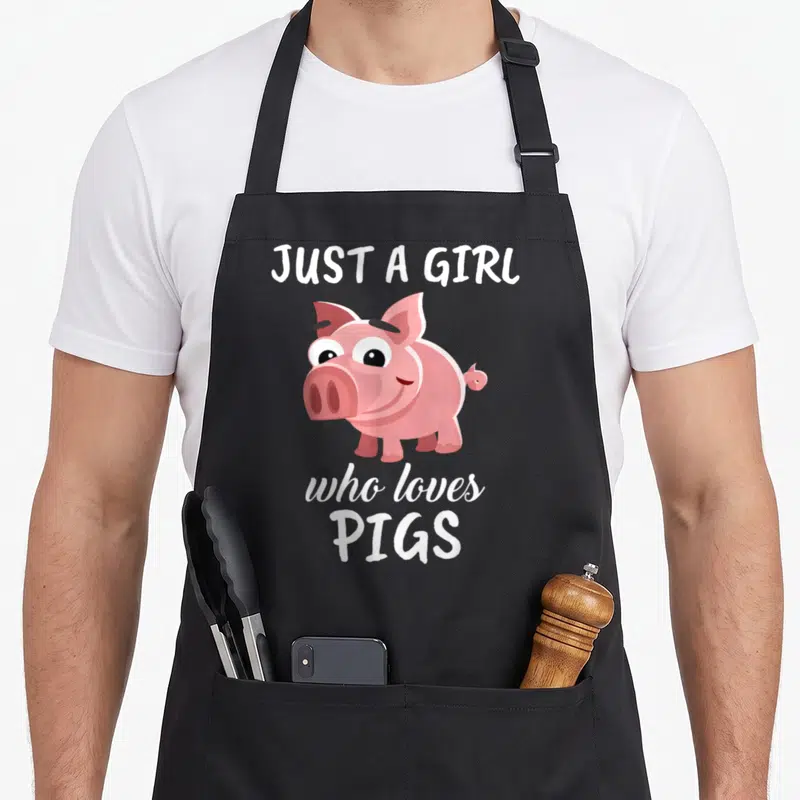 Tablier de cuisine noir avec illustration d'un cochon rose et du texte blanc Just a Girl Who Loves Pigs.