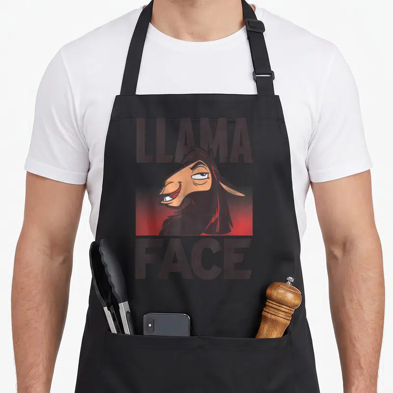 Tablier de cuisine noir avec illustration d'un lama au regard narquois et texte Llama Face en lettres capitales sombres sur fond rouge.