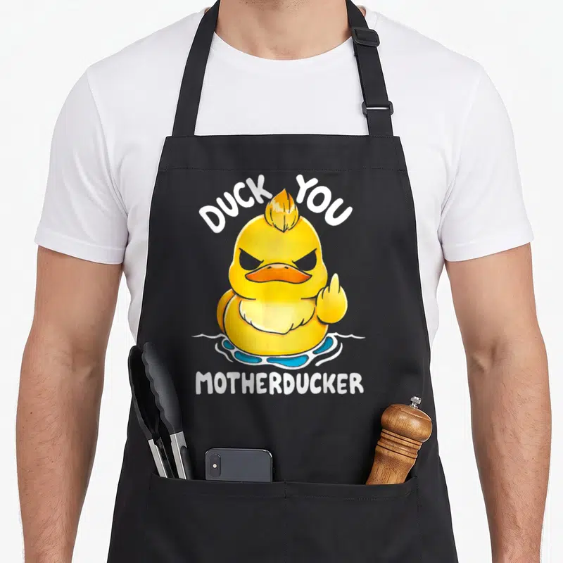 Tablier de cuisine noir avec un canard jaune méchant levant l'index et les textes Duck You Motherducker.