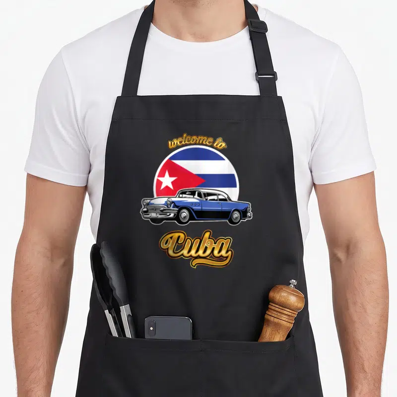 Tablier de cuisine noir avec illustration voiture vintage bleue et drapeau Cuba en arrière-plan circulaire.