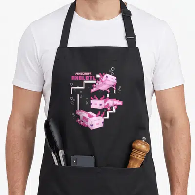 Tablier de cuisine noir avec trois axolots roses pixelisés flottant dans un étang stylisé Minecraft.
