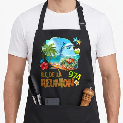 Tablier de cuisine noir avec illustration colorée d'un dauphin, d'un poisson clown et du texte Île de la Réunion 974.