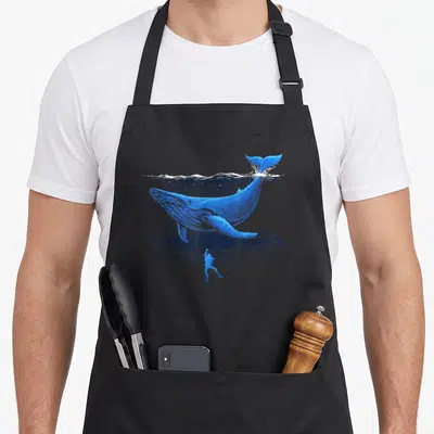 Tablier de cuisine noir avec illustration d'une baleine bleue et d'un plongeur sous-marin en style gravure.