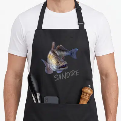 Tablier de cuisine noir avec illustration réaliste d'un sandre aux dents acérées et le mot SANDRE imprimé en dessous.