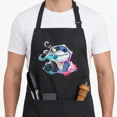 Tablier de cuisine noir avec un requin bleu stylisé Venom aux dents acérées et collier doré.