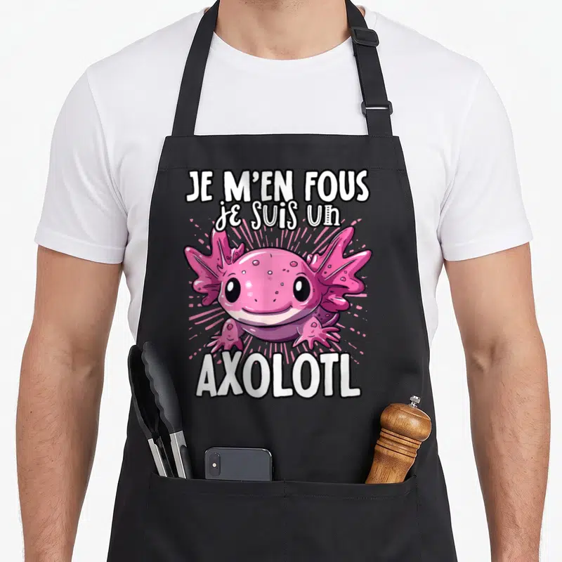 Tablier de cuisine noir avec un axolotl rose souriant et le texte Je m'en fous je suis un axolotl en blanc.