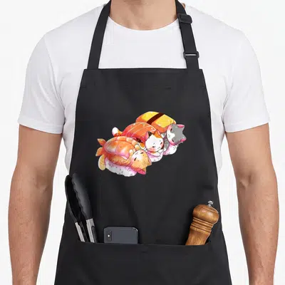 Tablier de cuisine noir avec trois chats kawaii stylisés en sushi aux couleurs pastels et éclats scintillants.