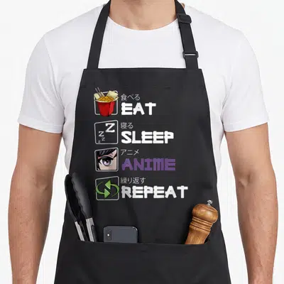 Tablier de cuisine noir avec motif Eat Sleep Anime Repeat illustré par des icônes kawaii et du texte en anglais et kanji.