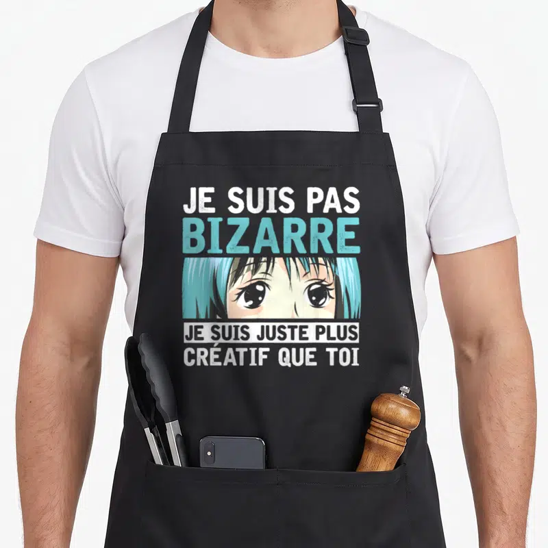 Tablier de cuisine noir avec illustration manga et texte humoristique sur la créativité