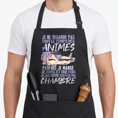 Tablier de cuisine noir avec illustration d'yeux fermés et texte blanc sur fond gris uni