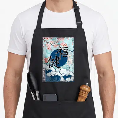 Tablier de cuisine noir avec illustration de vague japonaise, crane blanc et caractères calligraphiques noirs sur fond bleu.
