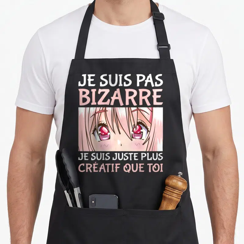 Tablier de cuisine noir avec illustration de yeux d'anime roses et texte humoristique en blanc et rose pastel.
